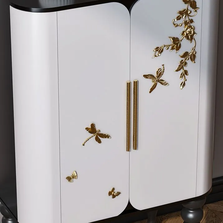White chest of drawers in the interior, decorated with polyurethane molding in the form of butterflies and botanical patterns.