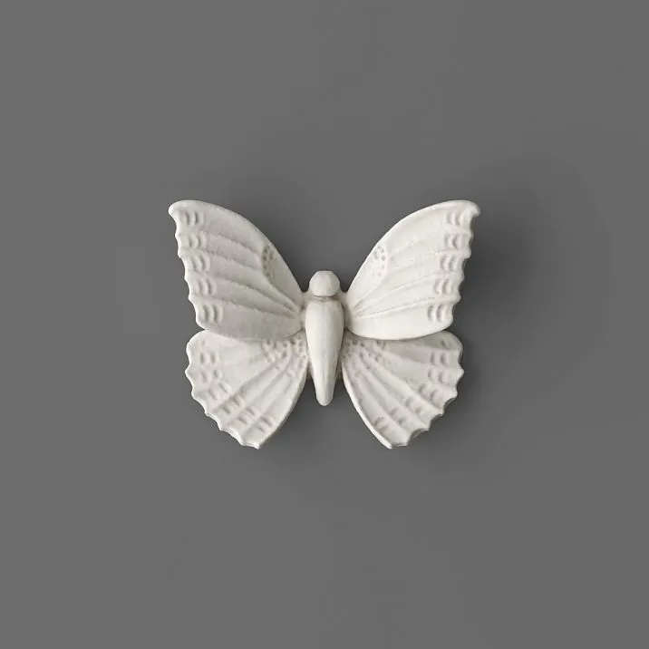 NPU-481 molding in the form of a white butterfly on a gray background.