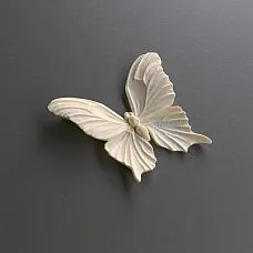 Room interior with a white chest of drawers decorated with polyurethane molding NPU-479 in the form of butterflies