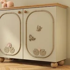 Relief decoration NPU-492L in the form of a bird, mounted on the facade of a furniture item,