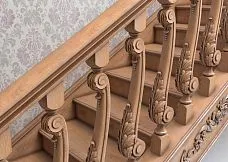 Wooden baluster L-005 with cylindrical or conical shape, view on the staircase