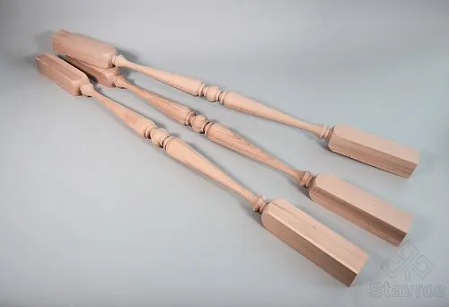 Three turned wooden balusters with square mounting bases