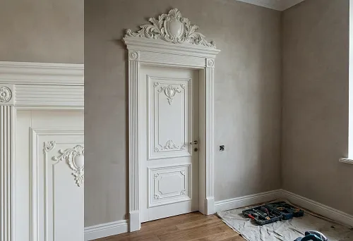 Polyurethane door portal: architraves with fluting and decorative pediment above the door