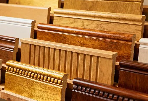 Samples of Wooden Skirting Boards in Various Shades and Shapes on a Display Stand