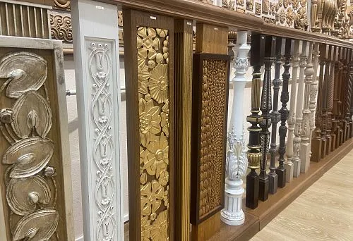 Collection of carved wooden balusters for staircases, crafted in various styles and finishes.
