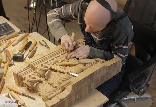 The Master Carves a Complex Relief Ornament by Hand from Solid Natural Wood