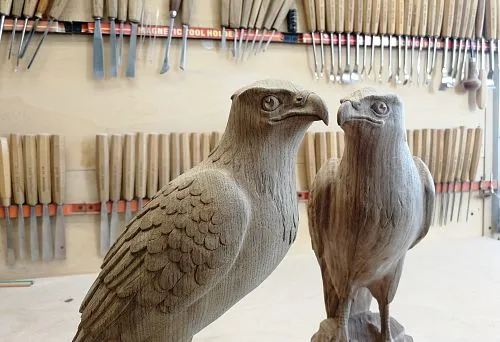 Detailed eagle figures created using artistic wood carving.