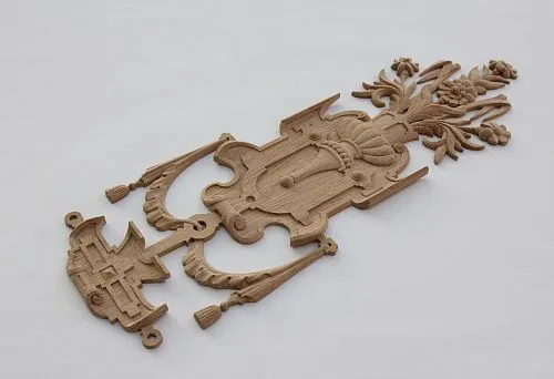 Carved decorative wooden element with floral ornament &mdash; example of unique decoration for furniture and interior.