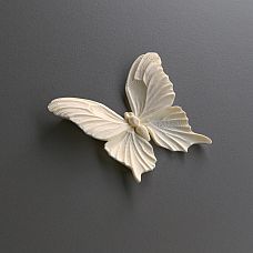 Room interior with a white chest of drawers decorated with polyurethane molding NPU-479 in the form of butterflies