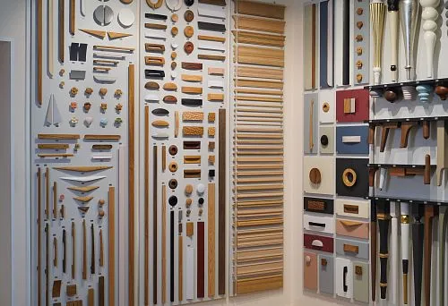 Exhibition stand featuring diverse wooden samples and decorative elements of various shapes and shades.