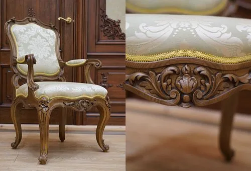 Close-up of decorative carving on the base of a chair, highlighting the luxurious style of upholstered furniture