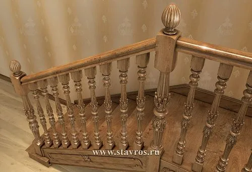 Carved balusters from solid wood and classic railings on the turn of the staircase landing