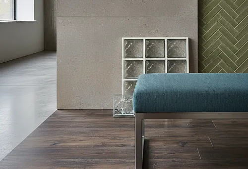 Modern interior: wear-resistant wall finish, concrete panel, green herringbone tile, dark wood floor