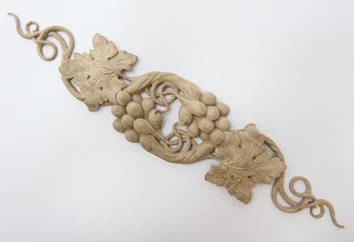 Carved wooden applique with grapevine for wall framing