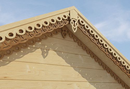 Carved decorative elements for a wooden house pediment