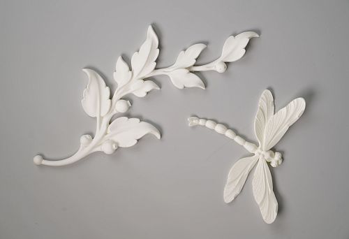 Polyurethane decorative element with floral and insect-like ornament