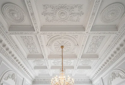 Molded ceiling in a classic interior with a luxurious chandelier