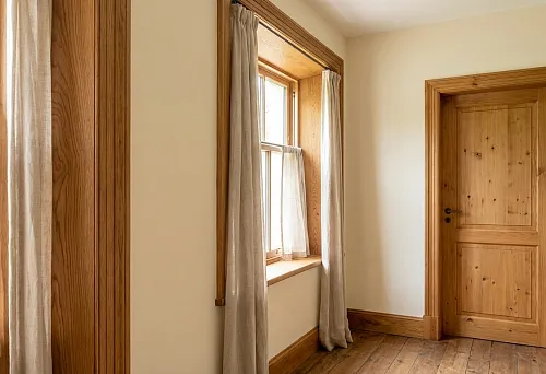 Wooden architrave on a door opening: neat door framing in a light interior