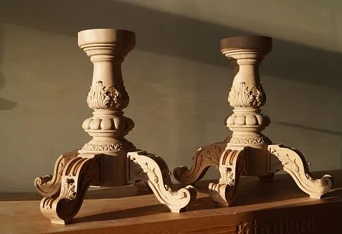 Wooden carved baseboards with solid round supports and curved legs