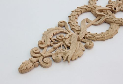 Wooden carved decorative element with classic ornament for window and facade decoration