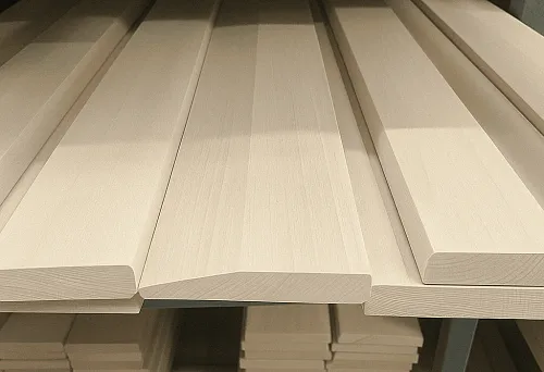 Smooth light-colored wooden skirting boards &mdash; elements for the perfect interior finish