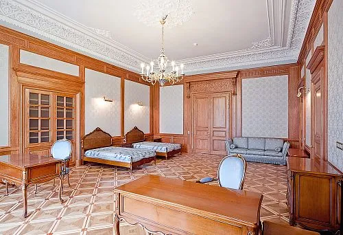 Elegant interior with solid wood furniture and ornate ceiling.