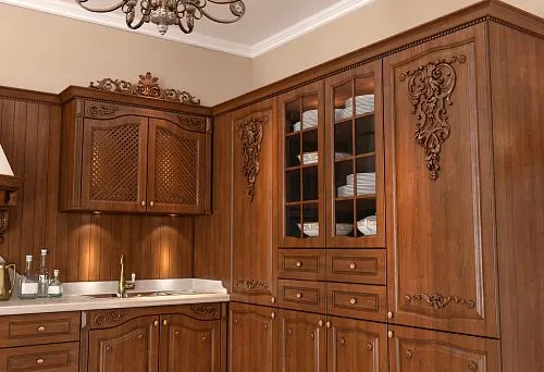 Kitchen made of natural wood with carved fronts and classic design