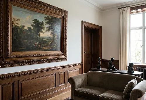 Large painting in a massive carved wooden frame, classic wooden baguette on the wall
