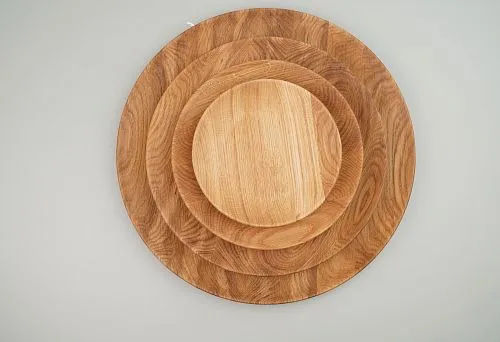 Set of Round Wooden Plates of Different Sizes, Neatly Stacked on Top of Each Other.