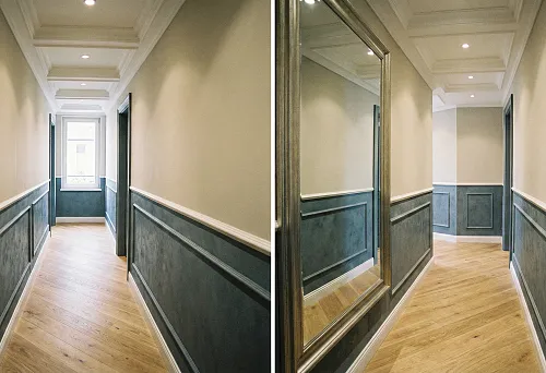 Hallway with decorative panels and moldings that visually elongate the space