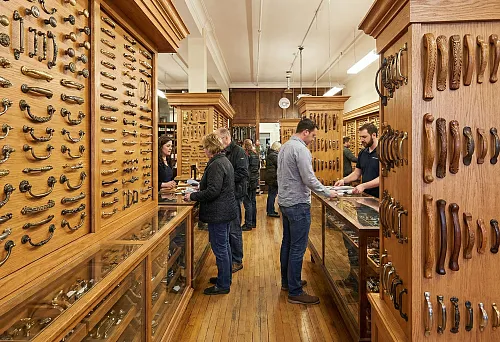 Showcase with furniture handles: wooden and metal models for classic furniture in the showroom