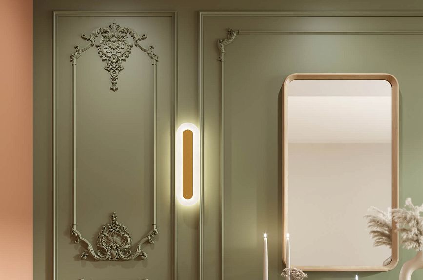 Stucco decor Tsarskoye Selo on an olive wall panel next to a mirror and vertical sconce