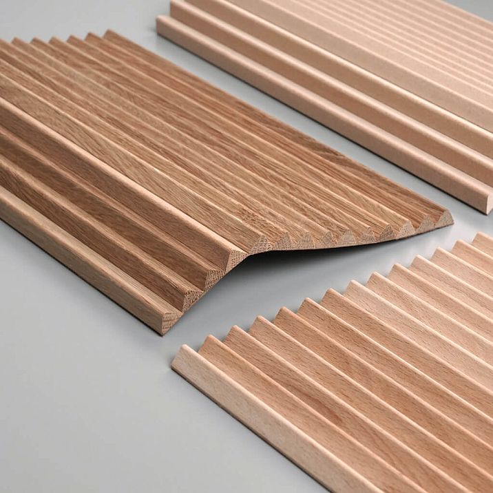 Close-up of the OPAN-005 slatted panel sample with a wood texture and profiled relief