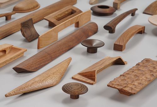 Assortment of Modern Wooden Furniture Handles in Various Shapes and Shades &ndash; Examples of Innovative Hardware for Furniture Manufacturing