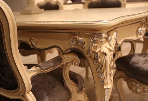 Elegant carved table base with silver decoration and smooth lines in classic style