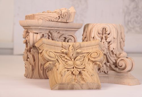 Carved decorative capitals and elements from natural wood for decorating a unique interior