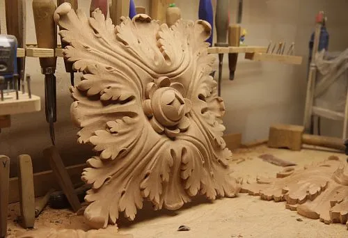 Carved wooden decor with classic ornament in workshop