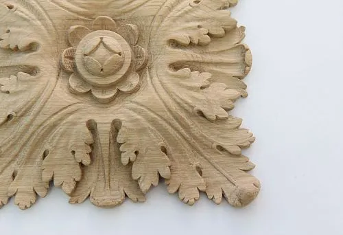Carved wooden decoration close-up &mdash; carved applique with leaves and flower, handmade, SPb