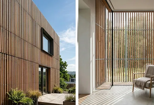 Slatted facade panels on a modern house, vertical exterior cladding with wooden slats