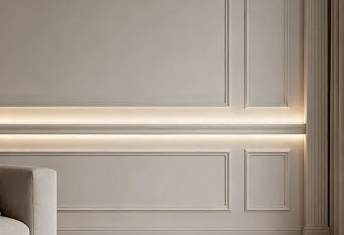 Modern interior with wall moldings and built-in lighting, creating soft diffused illumination along the perimeter of the walls.