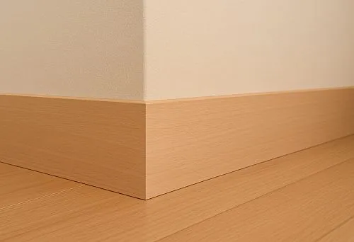 Straight light oak skirting board with smooth surface in modern interior