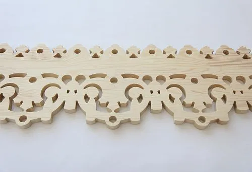 Carved wooden molding with an elegant pattern for decorating facades.