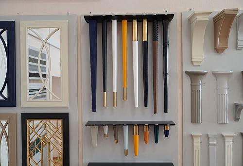 Collection of furniture legs in various shapes, colors, and finishes with metal inlays,