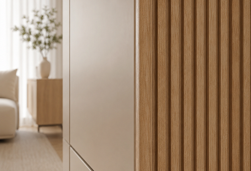 Cabinet adjacent to the slat wall with an open edge of the decorative panel