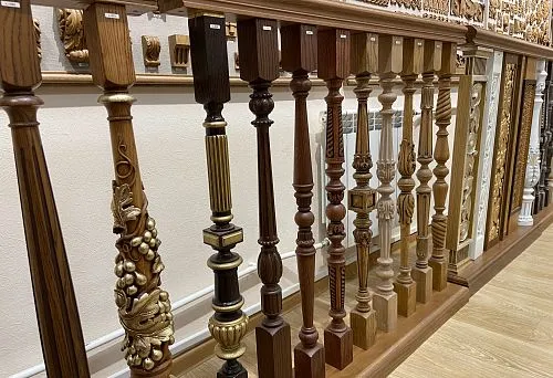 Various turned balusters of different wood species with carved and decorative elements