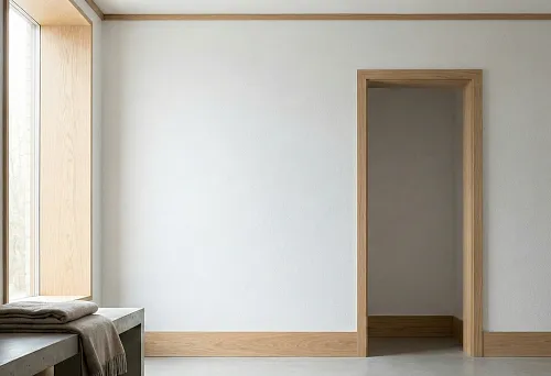 Minimalist interior with wooden baseboard and thin ceiling profile around the room perimeter