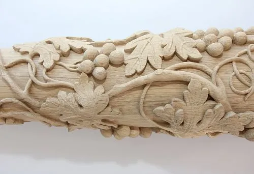 Complex carved detail from solid oak with grape leaves and clusters