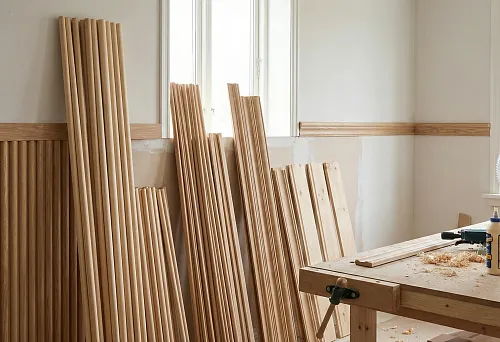 Wooden moldings and profiles in the workshop, blanks of various widths and shapes for wall finishing