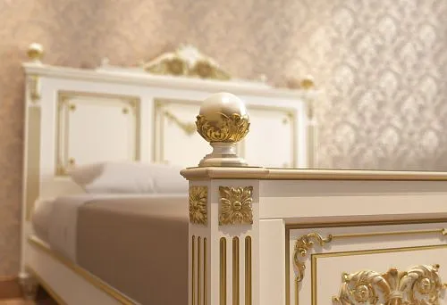 Classic solid wood bed with carved details and gilding
