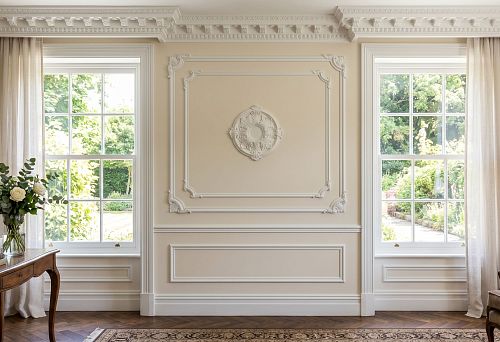 Wall molding decor between windows with polyurethane moldings